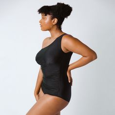 With a striking one-shoulder design, ample rows of shapely ruching, the Icon Swimsuit is our paragon of vintage-inspired glamour. The unique shape will have you drawing envious stares at the pool or seaside, and the Icon's easy fit and tug-free one-piece design prove that high-style can be effortless. This sexy modest suit stays in place whether you are splashing in the pool with your kiddos or paddle boarding at the lake. Large bust friendly (up to DD, then we recommend sizing up) Long torso fr One Shoulder Swimwear For Beach Party, Elegant One-shoulder Stretch Swimwear, Elegant One Shoulder Evening Swimwear, One-shoulder Swimwear For Evening Summer Events, One-shoulder Evening Swimwear For Summer, Elegant Black One-shoulder Swimwear, Black Ruched One Shoulder Top For Summer, Black Ruched One-shoulder Top For Summer, Albion Fit Swim