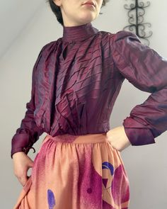 "Antique silk bodice c.1900. Made from a changeable shot silk, beautiful fabric, changes in the light from a dark pink to purple and blue. Full pouter style front bodice, high collar, full sleeves with mother of pearl cuff links. Boned and lined in cotton. Hooks and eye fastenings to inner bodice, outer blouse fuller also hook fastenings. Very good antique condition, hole in cotton lining, few scuffs to fabric. Strong and wearable. Chest 33\" Waist 26\" Across back seam to seam 12\" Collar 12\" Edwardian Blouse, Pearl Cuff, Gorgeous Blouses, Silky Blouse, Full Sleeves, Cuff Links, Lace Blouse, Cotton Lace, High Collar