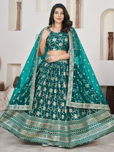 Our adorable teal green zari embroidered jacquard lehenga choli. This stunning ensemble features a teal green color jacquard lehenga with intricate zari embroidered work and sequin detailing. Paired with a matching jacquard choli adorned with similar zari embroidery and sequin work, along with a net dupatta featuring four side embroidered lace work, this outfit exudes elegance and charm.
The semi-stitched lehenga can be adjusted up to 42 inches, providing a comfortable and flattering fit for a w Festive Green Embroidered Lehenga, Semi-stitched Green Choli For Eid, Green Art Silk Lehenga With Zari Work, Green Art Silk Lehenga For Festive Occasions, Green Bollywood Choli In Dola Silk, Semi-stitched Green Choli For Navratri, Green Bollywood Art Silk Lehenga, Bollywood Style Green Art Silk Lehenga, Green Embroidered Bollywood Lehenga