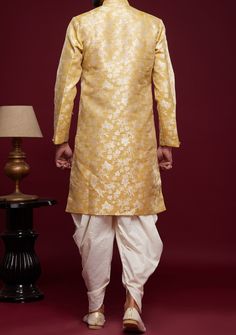 Ready-Made Sherwani With Peshawari Trouser. All Over Jacquard Brocade Style Fabric Top. Art Silk Peshawari Ready Made Trouser. Crafted in Chinese Collar Neck, and Full Sleeve. Satin Lining with Plain Work. High-Quality Matching Buttons. Please Note: The footwear shown in the picture is for presentation and photography purpose only. Color: There might be slight color variation due to lightings and flashes while photo shooting. The color may also vary because of different screen resolutions. Wash Chanderi Sherwani With Zari Work For Festivals, Festival Sherwani With Zari Work In Chanderi, Festive Unstitched Suit With Dabka And Traditional Drape, Semi-stitched Chanderi Sherwani With Cutdana, Unstitched Kurta In Raw Silk With Traditional Drape, Ceremonial Cutdana Kurta For Diwali, Ceremonial Raw Silk Kurta With Cutdana, Bollywood Style Festive Chanderi Sherwani, Semi-stitched Chanderi Sherwani With Zari Work