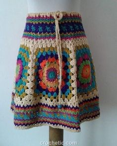 a crocheted skirt is displayed on a mannequin