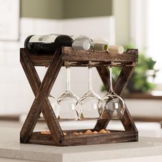 a wooden wine rack holding four wine glasses