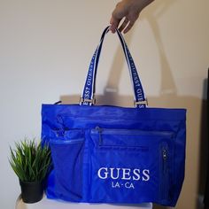 New With Tags Guess Travel Bag Nylon Material Royal Blue Large Duffle Bag New With Tag Blue Nylon Shoulder Bag For Travel, Blue Nylon Shoulder Bag With Adjustable Strap, Blue Rectangular Nylon Shoulder Bag, Blue Nylon Rectangular Shoulder Bag, Blue Nylon Travel Bag, Blue Nylon Shoulder Bag With Zipper, Nylon Shopping Bags With Double Handle, Functional Blue Nylon Shoulder Bag, Nylon Shoulder Bag For Shopping