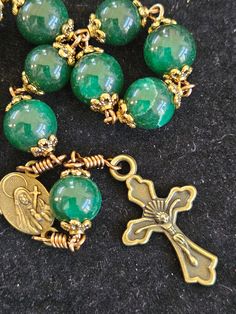 This handmade decade rosary is beautifullyhandcrafted.  It is made of 10mm emerald green 10mm  round stone beads.  Each bead is capped with antique bronze toned bead cap.  This chaplet is very pretty and elegant.    I connect each bead carefully with Artistic Wire Non Tarnish silver plated wire. Adjustable Green Spiritual Rosary, Adjustable Green Rosary With Round Beads, Green Beaded Spiritual Rosary, Green Spiritual Rosary Bracelet With Round Beads, Handmade Green Spiritual Rosary Bracelet, Spiritual Green Rosary Bracelet With Round Beads, Green Beaded Rosary, Handmade Green Rosary, Green Beaded Rosary With Round Beads