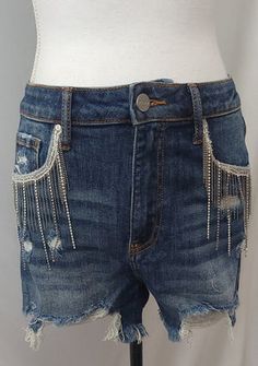 Trendy Jean Shorts With Rhinestone Fringe, Cutoff Denim Jean Shorts With Rhinestone Fringe, Rhinestone Jean Shorts For Summer, Festival Jean Shorts With Frayed Hem, Denim Jean Shorts With Rhinestone Fringe, Casual Jean Shorts With Rhinestone Fringe For Summer, Denim Cutoff Jean Shorts With Rhinestone Fringe, Summer Jean Shorts With Rhinestone Fringe, Trendy Summer Fringe Jean Shorts