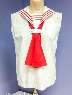 Sweet little Sailor style blouse, vintage from the 1950's, by Smart-Lee. For an item of this age it is in excellent condition. No holes or spots. Blouse has been washed. White & red 100% cotton. Sleeveless pullover blouse, with a button on inset panel, and button on red ties. Timeless, super cute summer top. Vintage size 10 measures: Bust-pit to pit-18" Shoulder appx-14 1/2" Length-22" *All of our vintage clothing is sold AS IS, and has not been dry cleaned or laundered unless otherwise stated. Any flaws or stains will be noted in the description, as well as any repairs that have been done in our shop. Vintage Sleeveless Tops For Daywear, Vintage Sleeveless Blouse For Daywear, Vintage Sleeveless Daywear Blouse, Retro Sleeveless Cotton Blouse, Vintage White Sleeveless Top, Sailor Vintage, Sailor Blouse, Vintage Red Blouse For Daywear, Classic White Sailor Collar Top