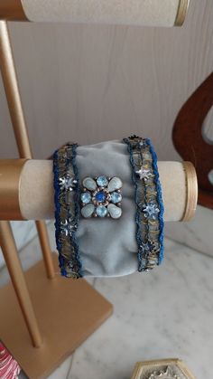 Handmade adjustable cuff created with old materials: Art Nouveau braid with gold thread and cabochon from the beginning of the 20th century, fully lined with blue satin. It is adjustable from 20.5 cm to 23 cm. The braid has been cleaned and restored. Its age gives it a unique patina and gives this cuff a charm that will only seduce you! Antique Adjustable Cuff Bracelet For Formal Occasions, Vintage Handmade Cuff Bracelet For Formal Occasions, Handmade Vintage Cuff Bracelet For Formal Events, Handmade Vintage Cuff Bracelet For Formal Occasions, Ornate Adjustable Cuff Bracelet For Formal Occasions, Formal Vintage Handmade Cuff Bracelet, Adjustable Victorian Cuff Bracelet For Formal Occasions, Handmade Adjustable Bracelet For Formal Occasions, Handmade Adjustable Cuff Bracelet For Party