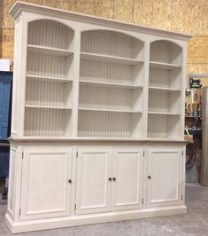 a large white bookcase sitting inside of a room