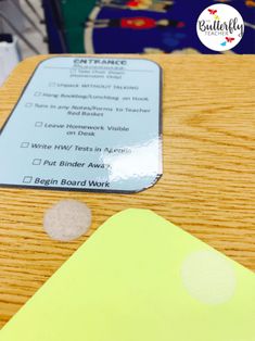 a close up of a wooden table with a card on it