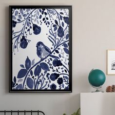 a blue and white wall hanging above a bed