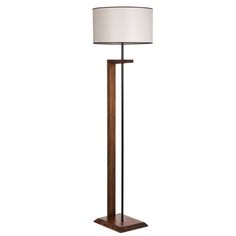 the floor lamp is made from wood and has a white shade on it's side