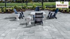 a table and chairs sitting on top of a stone floor next to a lush green park