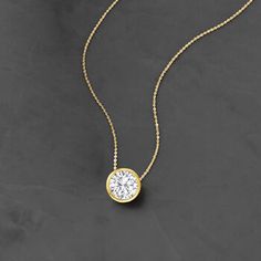 Ross-Simons - 1.20ct Bezel-Set Diamond Solitaire Necklace in 14kt Yellow Gold. 16". Utterly classic, this diamond necklace is a wardrobe essential. A marvelous 1.20 carat bezel-set round brilliant-cut diamond glows from polished 14kt yellow gold on a sleek box chain. Will add timeless diamond shimmer to your elegant everyday ensembles. Springring clasp, diamond necklace. Diamond birthstones are the perfect gift for April birthdays. Luxury Timeless Solitaire Diamond-cut Necklace, Luxury Classic Solitaire Necklace With Brilliant Cut, Diamond Solitaire Necklace Size, Luxury Dainty Diamond Necklace With Brilliant Cut, Luxury Solitaire Diamond Necklace Vs Clarity, Delicate Diamond Necklace Pendant, Diamond Solitaire Necklace Setting, Single Diamond Necklace, Diamond Necklace Simple