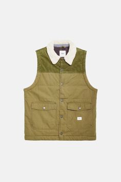 The Yukon Vest is a 100% cotton snap-down vest made from a cotton canvas shell that offers a custom sherpa body liner, & front pockets. 100% cotton canvas shell 100% cotton corduroy upper chest, shoulders and collar Front snap closure Front pockets Sherpa liner Khaki Cotton Vest Outerwear, Military Cotton Vest For Streetwear, Military Style Cotton Vest Outerwear, Outdoor Cotton Vest With Patch Pockets, Khaki Cotton Utility Vest, Cotton Vest With Patch Pockets For Fall, Khaki Cotton Vest For Fall, Green Cotton Winter Vest, Green Cotton Vest For Winter