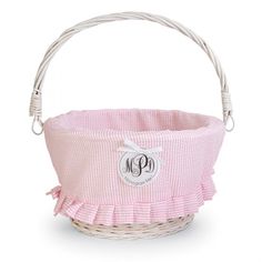 a pink and white basket with a monogrammed bow