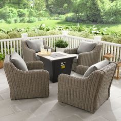 an outdoor patio with wicker furniture and potted plants