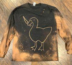 a long sleeve shirt with an image of a duck on it