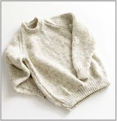 two sweaters sitting next to each other on a white surface