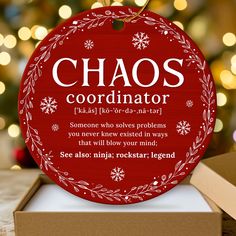 a christmas ornament with the words chaos coordinates on it and snowflakes