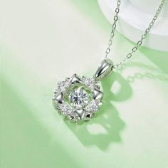 An eye-catching round moissanite dances with ease at the center of this appealing women's necklace, expressing your unstoppable love. Additional round gem set in sterling silver frame the center. Features Moissanite was originally found in meteorites(Chemical name: Silicon Carbide). It was first discovered in 1893, while a scientist was examining meteor samples from a crater in Arizona. After many years, the experts has been recreated moissanite in the laboratory, that make the gemstone with fri Women's Necklace, Silicon Carbide, Moissanite Necklace, Moissanite Jewelry, Round Moissanite, Timeless Jewelry, Stone Cuts, Silver Frame, Prong Setting