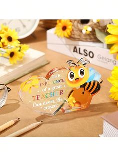 a desk with sunflowers, pencils and an acrylic sign on it