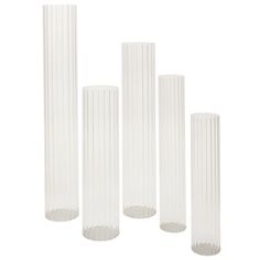 four tall white vases sitting next to each other