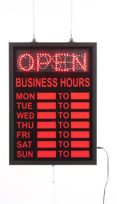 an open business hours sign hanging from the side of a building with red letters on it