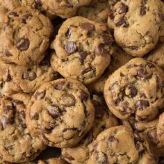 a pile of chocolate chip cookies sitting on top of a table