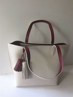 NWT Kate Spade Foster Court Tasha Leather Tote Handbag WKRU3832 Ivory $399 NEW Style: Foster Court Tasha Style #: WKRU3832 Dimension: 17" L x 13" H x 6" D Color: Pebble/Dark Red Material: Genuine Leather You are looking at a brand new Foster Court Tasha Leather Tote by KATE SPADE. This beautiful handbag is BRAND NEW and 100% AUTHENTIC. Features: Pebbled leather Polished 14K light gold hardware Double handles with 9" drop     Open top with two leather fringe tassels  Interior leather color: dark Bags Handmade, Beautiful Handbags, Leather Handbags Tote, Leather Bags Handmade, Tote Handbag, Leather Fringe, Tassel Fringe, Open Top, Leather Bags