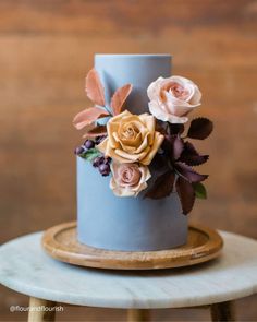 a blue wedding cake with flowers on top