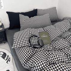 a black and white checkered comforter with headphones on it in a bedroom