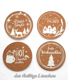 four cork coasters with christmas designs on them