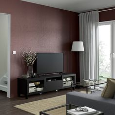 a living room filled with furniture and a flat screen tv on top of a stand