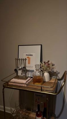 a bar cart with drinks and liquor on it