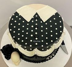 a black and white cake with polka dots on it