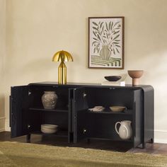 a black cabinet with two shelves and some vases