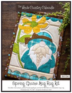 a close up of a patchwork quilt on a wooden surface with text that reads spring gnome mug rug kit