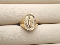 women's Virgin Mary Miraculous Medal ring made in 14k, 18k solid goldthe Miraculous Medal is devotional medal, the original design was executed by Adrien Vachette based on Saint Catherine Laboure visions.the Miraculous medal with exquisite details is on the top of this ring.medal height 15.7mm, width 11.5mm (on 6.5 US)* the larger ring size, the bigger medal size is.14k gold womens ring weight (edited on 20 dec 29th)5.0 US 2.61g (±7%)5.5 - 6.0 US 2.93g (±7%)6.5 US 3.27g (±7%)7.0 - 7.5 US 3.64g ( Spiritual Yellow Gold Tarnish-resistant Signet Ring, 14k Yellow Gold Engraved Ring For Commemoration, Spiritual 14k Gold Oval Signet Ring, Spiritual Oval Engraved Ring In Yellow Gold, Spiritual Yellow Gold Engraved Oval Ring, Spiritual Engraved Yellow Gold Oval Ring, Spiritual Engraved Oval Yellow Gold Ring, Spiritual Oval Engraved Yellow Gold Ring, 14k Gold Oval Signet Ring For Commemoration