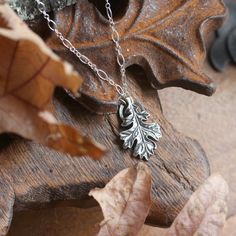 "Hand sculpted fine silver oak leaf pendant. A botanical talisman symbolic of reverence for nature ~ complete with its very own little halo. A wearable idol for every day! The oak is regarded across the world as a symbol of wisdom, strength and endurance. Available on its own or strung from your choice of elegant sterling silver chain or leather cord for a more casual look. This pendant represents a substantial amount of solid fine silver (.999 / 99.9% pure silver) and has a lovely weight and fe Nature-inspired Pendant Jewelry With Charms, Nature-inspired Pendant Charms Jewelry, Nature-inspired Oxidized Pendant Jewelry, Nature-inspired Jewelry Pendant With Oxidized Finish, Nature-inspired Pendant Jewelry With Oxidized Finish, Nature-inspired Hand Cast Pendant Jewelry, Nature-inspired Hand-cast Pendant Jewelry, Hand-cast Pendant Necklace With Nature-inspired Style, Hand Cast Nature-inspired Pendant Necklace