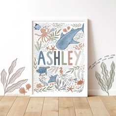 an art print with the words ashley surrounded by sea animals and corals on a white wall