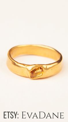 an image of a gold ring with a stone