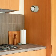 a stove top oven sitting inside of a kitchen next to a wooden cabinet and counter