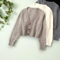 Featuring a classic cable knit design, v-neckline, and oversized fit, this cardigan is perfect for layering over your favorite fall outfits. Available in a variety of neutral colors to complement any wardrobe. Size: - Bust: 104cm, Sleeve: 60cm, Length 53cm (Please check size chart) Material: - Cotton Blend, Polyester Key Features - Chunky Cable Knit - Cropped Length - V-Neckline Please Note: Due to the handmade nature of our robes and kimonos, and variations in fabric and manufacturing processes, please allow for slight discrepancies in sizing.  Finished garment measurements may differ from the size chart by 1-3cm. We appreciate your understanding! Fall Cardigan, Cardigan Oversized, Button Up Sweater, Chunky Cable Knit, Cable Knit Cardigan, Knit Crop, Cute Sweaters, Cropped Cardigan, Cozy Fall