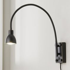 a black wall light with a white background