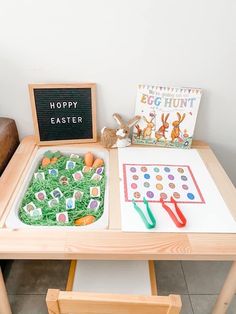 a child's play table with an egg hunt board, scissors and carrots