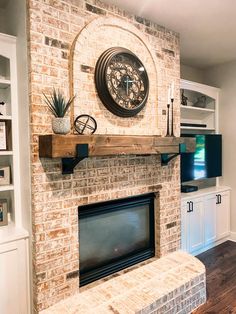 a living room with a brick fireplace and clock on the wall above it's mantle