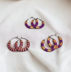 Show your team spirit and represent your game day team colors with these stunning purple and metallic gold heishi bead stainless steel hoop earrings.  - Available in 2 sizes: 1" and 1.5" - Three unique designs to choose from Make a statement and cheer on your team in style with these trendy earrings. Perfect for game day or any occasion. Grab a pair now and show your support! Handmade Purple Heishi Beads Jewelry, Adjustable Nickel-free Purple Hoop Earrings, Adjustable Small Purple Hoop Earrings, Nickel-free Purple Hoop Earrings, Beaufort Nc, Spirit Game, Bead Hoop Earrings, Purple Metallic, Team Mom