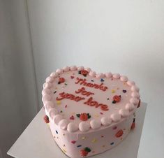 a heart shaped birthday cake with confetti and sprinkles on it