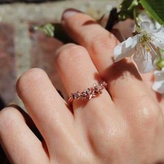 Cherry Blossom Ring, sakura ring – Silver/Gold/Rose Gold/White Gold, flower ring, engagement ring, promise ring, wedding band, wedding ringThis beautiful cherry blossom ring is delicate and elegant. Ring features 5 intricate cherry blossom flowers and buds, nestled on a pretty cherry tree branch in a chevron shape.  Cherry blossoms are revered around the world for their overwhelming beauty, and their ephemeral, fleeting nature serves as a little reminder to be present, appreciative and mindful e Rose Gold Flower-shaped Promise Ring, Rose Gold Flower Ring For Promise, Rose Gold Crystal Ring For Proposal, Rose Gold Flower Promise Ring, Elegant Blossom Flower Rings, Elegant Blossom Wedding Rings, Elegant Blossom Color Wedding Rings, Elegant Blossom Color Flower Rings, Elegant Blossom Colored Rings For Gift