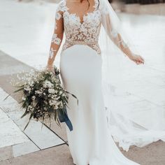 a woman in a wedding dress holding a bouquet